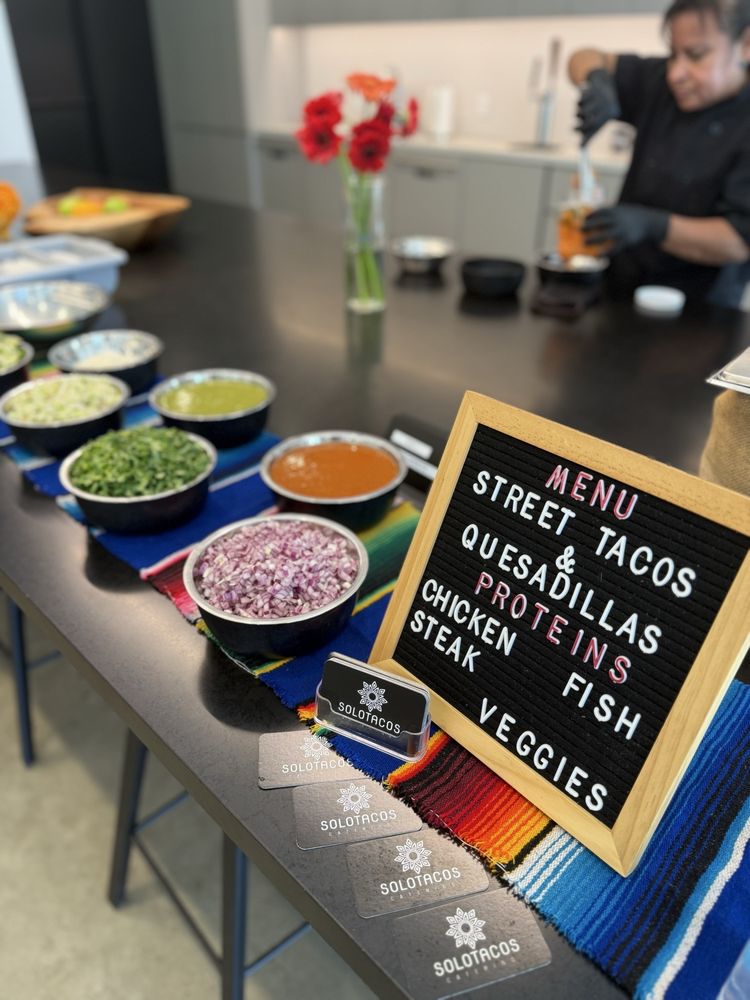 Solo Tacos buffet setup with staff
